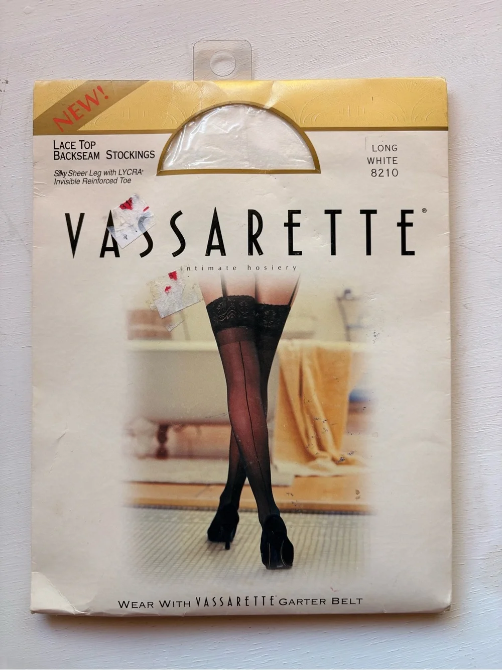 vassarette White & Gold Hosiery Packaging with Black Stocking Image